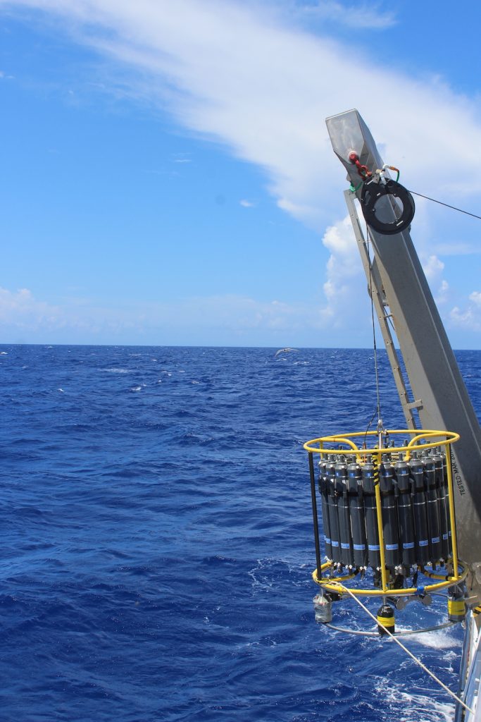 The CTD being carefully deployed off the starboard side of the boat. Two ropes held by technicians make sure the structure enters the water straight